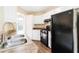 Kitchen showcasing black appliances, white cabinets, and a sink with countertop at 7186 Raintree Loop, Jonesboro, GA 30236