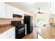 Kitchen with black appliances, white cabinets, and an adjacent breakfast nook at 7186 Raintree Loop, Jonesboro, GA 30236