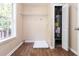 The laundry room features wood look flooring and a shelf and rod for additional storage at 7186 Raintree Loop, Jonesboro, GA 30236