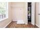 Functional laundry room with laminate floors, a utility sink, and ample storage space at 7186 Raintree Loop, Jonesboro, GA 30236