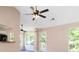Spacious living area with high ceilings, ceiling fans, a doorway to the back patio, and a breakfast bar at 7186 Raintree Loop, Jonesboro, GA 30236
