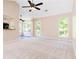 Spacious living room featuring carpet, ceiling fan, and access to an outdoor patio or balcony at 7186 Raintree Loop, Jonesboro, GA 30236