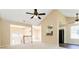 Open-concept living space featuring light-colored walls, carpeted floors, and high ceilings with fans at 7186 Raintree Loop, Jonesboro, GA 30236