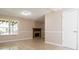 A cozy room with a decorative fireplace, neutral trim, and large window to the backyard and deck at 7186 Raintree Loop, Jonesboro, GA 30236