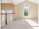 Bright living room with vaulted ceiling, chandelier, large window, carpeted floors, and light walls at 7186 Raintree Loop, Jonesboro, GA 30236