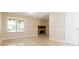 Open living room featuring tile floors, a decorative fireplace, and a large window at 7186 Raintree Loop, Jonesboro, GA 30236