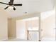 Bright living area featuring carpeted floors, ceiling fan, large window and light-colored walls at 7186 Raintree Loop, Jonesboro, GA 30236