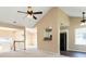 Open living area with high ceilings, ceiling fans, a breakfast bar, and a view to the front entryway at 7186 Raintree Loop, Jonesboro, GA 30236