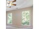 Spacious primary bedroom featuring a trey ceiling, ceiling fan, and large windows at 7186 Raintree Loop, Jonesboro, GA 30236