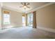 Bright bedroom with carpet, large windows, and access to backyard through sliding glass doors at 308 Rusty Gate Pass, Woodstock, GA 30189