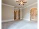Spacious bedroom with neutral walls, plush carpet, and archway leading to bathroom at 308 Rusty Gate Pass, Woodstock, GA 30189