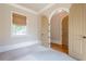 Cozy bedroom featuring neutral carpet, arched doorways, and a large window with a window shade at 308 Rusty Gate Pass, Woodstock, GA 30189