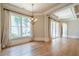 Bright dining room with chandelier, hardwood floors, and large windows at 308 Rusty Gate Pass, Woodstock, GA 30189