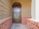 Elegant arched front door with brick trim and sidelight windows exudes sophisticated curb appeal at 308 Rusty Gate Pass, Woodstock, GA 30189