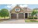 Charming home featuring a brick driveway, two-car garage, and manicured landscaping at 308 Rusty Gate Pass, Woodstock, GA 30189