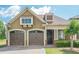Charming home featuring a brick driveway, two-car garage, and manicured landscaping at 308 Rusty Gate Pass, Woodstock, GA 30189