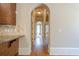 Inviting hallway featuring hardwood floors, arched doorways, and neutral wall paint at 308 Rusty Gate Pass, Woodstock, GA 30189