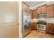 Kitchen with stainless steel appliances and wood cabinets at 308 Rusty Gate Pass, Woodstock, GA 30189