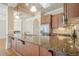 Kitchen island with granite countertops, stainless steel appliances, and wood cabinets at 308 Rusty Gate Pass, Woodstock, GA 30189