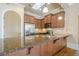 Kitchen with granite countertops, stainless steel appliances, and wood cabinets at 308 Rusty Gate Pass, Woodstock, GA 30189