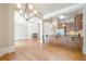Living room with hardwood floors, fireplace, kitchen, and coffered ceiling at 308 Rusty Gate Pass, Woodstock, GA 30189