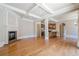 Spacious living room with hardwood floors, fireplace, and coffered ceiling open to the kitchen at 308 Rusty Gate Pass, Woodstock, GA 30189