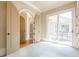 Bright living space with arched doorways, neutral carpet, and sliding glass doors to the outdoor patio at 308 Rusty Gate Pass, Woodstock, GA 30189