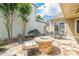 Charming outdoor patio with stone fire pit, dining table, and seating area, ideal for relaxing and entertaining at 308 Rusty Gate Pass, Woodstock, GA 30189