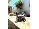 Stone patio featuring a stone fire pit, dining table, and comfortable seating creating an inviting outdoor space at 308 Rusty Gate Pass, Woodstock, GA 30189
