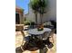 An outdoor patio with a stylish dining table, stone tile floor, and a cozy fire pit for enjoyable moments at 308 Rusty Gate Pass, Woodstock, GA 30189