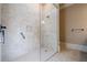 Walk-in shower featuring floor to ceiling tile, and glass partition at 308 Rusty Gate Pass, Woodstock, GA 30189