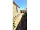 Exterior side yard pathway with stone walkway, landscaping, and fencing creating a charming and private outdoor space at 308 Rusty Gate Pass, Woodstock, GA 30189