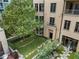 A lovely backyard with lush green grass, stone pavers, a small tree, and outdoor chairs, perfect for relaxation at 3376 Peachtree Rd # 1, Atlanta, GA 30326
