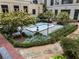 Tranquil courtyard featuring a fountain, lush greenery, and manicured landscaping at 3376 Peachtree Rd # 1, Atlanta, GA 30326