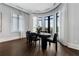Bright dining room with dark hardwood floors, floor-to-ceiling windows, and modern black dining set at 3376 Peachtree Rd # 1, Atlanta, GA 30326