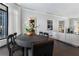 Dining area with dark hardwood floors, modern table, and open access to the living area at 3376 Peachtree Rd # 1, Atlanta, GA 30326