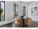 Elegant dining room with hardwood floors, ample windows, and a modern table set at 3376 Peachtree Rd # 1, Atlanta, GA 30326