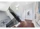 Hallway with hardwood floors and modern staircase featuring wrought iron railings at 3376 Peachtree Rd # 1, Atlanta, GA 30326