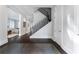 Inviting home entrance with gleaming hardwood floors, staircase with black metal railing and neutral tones at 3376 Peachtree Rd # 1, Atlanta, GA 30326
