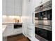 Modern kitchen featuring white cabinets, stainless steel appliances, and marble countertops at 3376 Peachtree Rd # 1, Atlanta, GA 30326