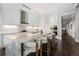 A stylish kitchen with white cabinets, marble countertops, a sleek island, and dark hardwood floors at 3376 Peachtree Rd # 1, Atlanta, GA 30326