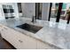 Marble countertop with stainless steel sink and fixtures, in a well-lit kitchen at 3376 Peachtree Rd # 1, Atlanta, GA 30326