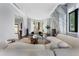 Bright living room with a fireplace, curved sofa, bay window and dark hardwood flooring at 3376 Peachtree Rd # 1, Atlanta, GA 30326