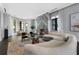 Open concept living space with a fireplace, modern sofa, bay windows and hardwood floors at 3376 Peachtree Rd # 1, Atlanta, GA 30326