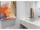 Modern powder room featuring a floating marble sink, contemporary faucet and stylish wall art at 3376 Peachtree Rd # 1, Atlanta, GA 30326