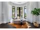 Cozy sitting area with a curved couch, bay windows, and a view of the outdoors, creating a serene atmosphere at 3376 Peachtree Rd # 1, Atlanta, GA 30326