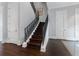 Elegant staircase featuring dark wood steps, iron railing, and white trim, adding a touch of modern style at 3376 Peachtree Rd # 1, Atlanta, GA 30326