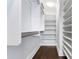 Spacious walk-in closet with custom shelving and dark wood floors at 3376 Peachtree Rd # 1, Atlanta, GA 30326