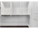 Walk-in closet featuring three tier closet rods and a built-in organization system at 3376 Peachtree Rd # 1, Atlanta, GA 30326