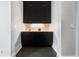 Elegant wet bar with dark cabinetry, a marble countertop, and modern fixtures at 3376 Peachtree Rd # 1, Atlanta, GA 30326